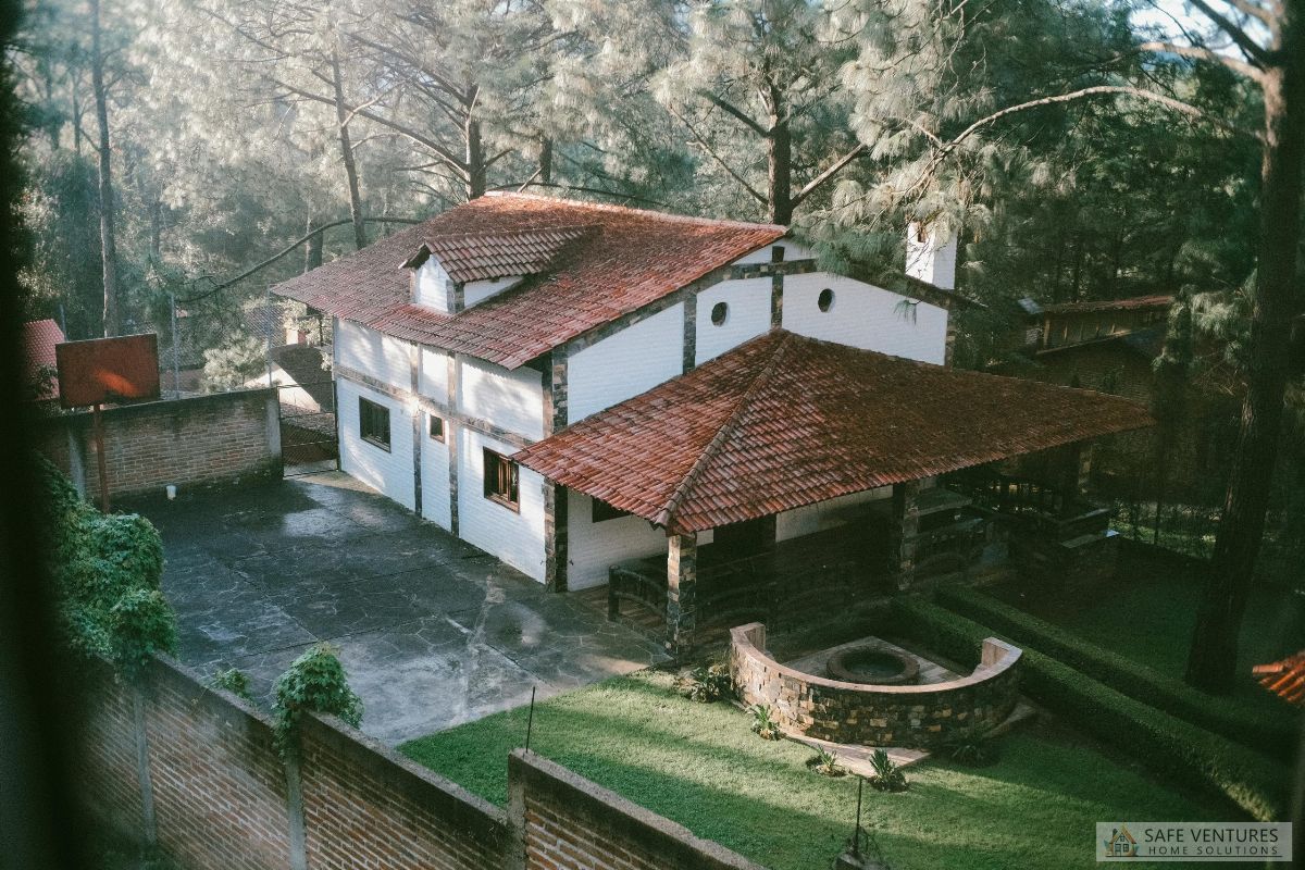 a farm house in the woods with the yard